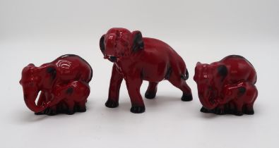 A ROYAL DOULTON FLAMBE MODEL OF AN ELEPHANT 13cm high, together with two smaller groups of