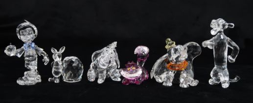 SIX SWAROVSKI CRYSTAL WALT DISNEY CHARACTERS including Pinocchio, Dumbo, The Cheshire Cat, Eeyore,