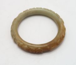 A CHINESE HARDSTONE CARVED BANGLE  decorated with calligraphy,scrolls and foliage, 68 grams, 9cm di