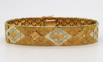 A THREE COLOUR GOLD BRACELET Italian made, stamped 750, with engraved flower pattern to the