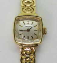 AN 18CT GOLD CERTINA WATCH with a white dial with gold coloured baton numerals and black baton