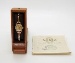 A LADIES OMEGA WRISTWATCH both the case and the strap are in 9ct gold, inscribed and dated 1955,