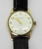 A 9CT GOLD GARRARD WATCH with cream dial, subsidiary seconds dial, gold Arabic numerals and hands.