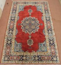 A CREAM GROUND NAIN RUG with a blue and red central medallion, matching spandrels on