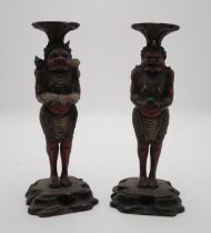 A PAIR OF CARVED WOOD,POLYCHROME AND GESSO ONI CANDLESTICKS  each demon standing and facing