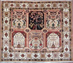 A PEACH GROUND HERIZ RUG  decorated with six panelled ground with foliate and urn designs and flower