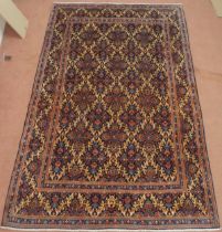 A DARK BLUE GROUND MOOD RUG with all-over medallion design and multiple