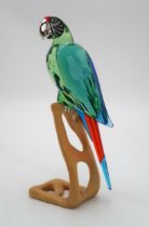 A SWAROVSKI CRYSTAL BIRDS OF PARADISE  FIGURE of a Macaw on wooden base, 23cm high Condition