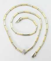 A DIAMOND FLOWER NECKLACE the baton links of yellow and white metal have a four petaled flower in