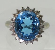 A BLUE TOPAZ & DIAMOND CLUSTER RING set in 9ct white gold, the central topaz approx 12mm x 10mm,