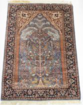 A BLUE GROUND PERSIAN TREE OF LIFE PATTERN RUG  decorated with stylized animals within flower head