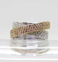 A STYLISH TWIST DIAMOND RING made in 18ct yellow and white gold and set with champagne and white