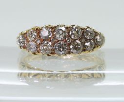 A DIAMOND CLUSTER RING in a classic scroll mount, set with estimated approx 0.78cts of old cut