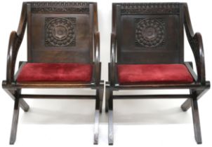 A PAIR OF VICTORIAN OAK GLASTONBURY CHAIRS  backs carved with ecclesiastical motifs over central