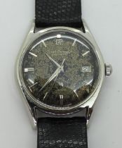 A VINTAGE GIRARD PERREGAUX the stainless steel gents Gyromatic watch, has a patinaed dial, silver