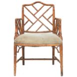 A 20TH CENTURY AFTER CHIPPENDALE CHINOISERIE STYLE FAUX BAMBOO ARMCHAIR  with "Cockpen" fretwork