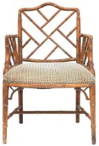 A 20TH CENTURY AFTER CHIPPENDALE CHINOISERIE STYLE FAUX BAMBOO ARMCHAIR  with "Cockpen" fretwork