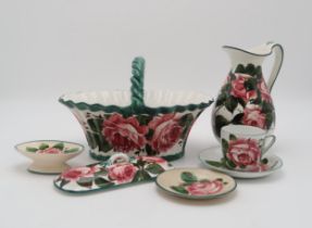 A COLLECTION OF WEMYSS CABBAGE ROSE PAINTED  POTTERY including a basket with twisted handle, 29cm