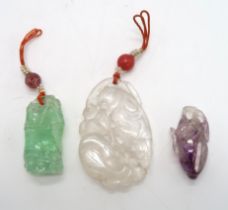 THREE CHINESE ROCK CRYSTAL PENDANTS one carved as a bamboo section,4.5cm high,a fruit, 4cm high and