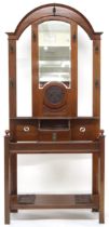 AN EDWARDIAN MAHOGANY HALL STAND  with moulded arched top over central bevelled glass mirror flanked