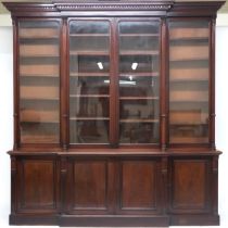 A LARGE VICTORIAN MAHOGANY BREAKFRONT LIBRARY BOOKCASE  with moulded dentil cornice over pair of