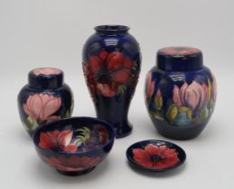 A COLLECTION OF MOORCROFT POTTERY including two Magnolia pattern ginger jars, one with an anemone