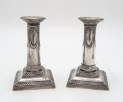 A PAIR OF LATE VICTORIAN SILVER CANDLESTICKS by Thomas Bradbury, London 1899, of column form, with