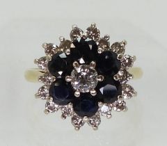 A SAPPHIRE & DIAMOND CLUSTER RING mounted in 18ct yellow gold the classic flower formation is set