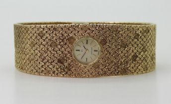 A LADIES RETRO OMEGA the 9ct wide cuff style woven bracelet has all over texture, with a 1cm wide