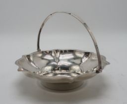 A GEORGE V SILVER SWING-HANDLED BASKET by Cooper Brothers & Sons, Sheffield 1927, of lobed form,