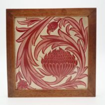 WILLIAM DE MORGAN (1839-1917) A red lustre tile depicting a closed sunflower bud and foliage, in