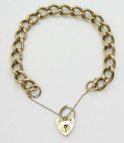 A CURB LINK BRACELET in solid 9ct gold with heart shaped clasp. Length 20.5cm, weight 35gms