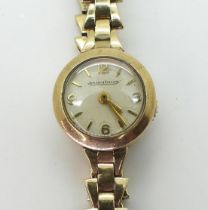 A LADIES JAEGER LECOULTRE WATCH in 9ct gold with a fancy link strap, the cream dial with Arabic
