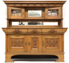 A LATE VICTORIAN OAK ARTS & CRAFTS SIDEBOARD  with moulded cornice over central rectangular bevelled