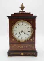 A FRENCH MAHOGANY MANTEL CLOCK the case with inlaid brass details, and pineapple finial, the