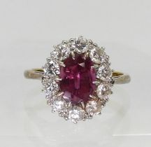 AN 18CT GOLD RING set with an oval pink gem, surrounded with 0.80cts of brilliant cut diamonds, to