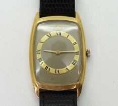 A LADIES JAEGER LE COULTRE with an 18k gold tonneau case, beige dial with gold coloured chapter ring