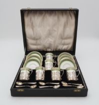 A CASED SET OF SILVER MOUNTED PORCELAIN COFFEE CANS the porcelain by Crescent China, the silver by