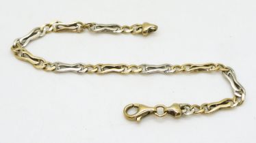 A YELLOW AND WHITE GOLD BRACELET stamped 375 to the clasp and chain end, with alternated fancy links