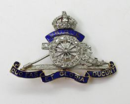 A ROYAL ARTILLERY SWEETHEART BROOCH made in yellow and white metal, with blue and red enamel