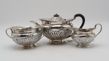 AN EDWARDIAN THREE PIECE SILVER TEA SERVICE by Atkins Brothers, Sheffield 1904, of squat form,