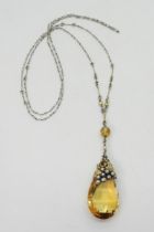 A CITRINE VINE PENDANT Probably made by DORRIE NOSSITER. With a grape and vine theme, the yellow