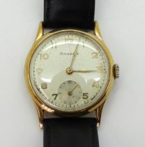 A 9CT GOLD PINNACLE WRISTWATCH with cream dial, subsidiary seconds dial, gold coloured Arabic