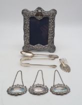 A collection of silver including a pair of George III silver sugar tongs, London 1810?, maker's mark