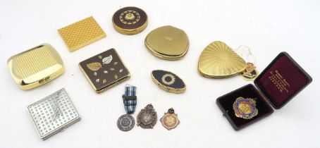 A collection of powder compacts, to include an example with Scots Guards badge applied to lid,