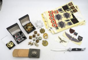 A collection of replica WW2 German Third Reich items, comprising a small folding knife, large-