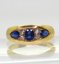 A heavy dome ring set with sapphires and old cut diamonds. The diamonds are estimated approx at 0.