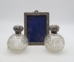 A pair of silver topped scent cut crystal bottles, by Walker & Birmingham, of spherical form, and