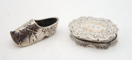 A Victorian silver vinaigrette, by Neill & Cook, Birmingham 1857, of shaped form, with scrolling