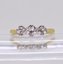 An 18ct gold and platinum three stone diamond ring, set with estimated approx, 0.70cts of old cut